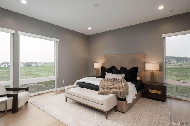 bedroom with recessed lighting, baseboards, and light wood finished floors
