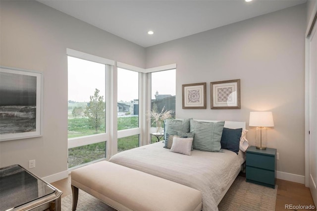 bedroom featuring recessed lighting, wood finished floors, and baseboards
