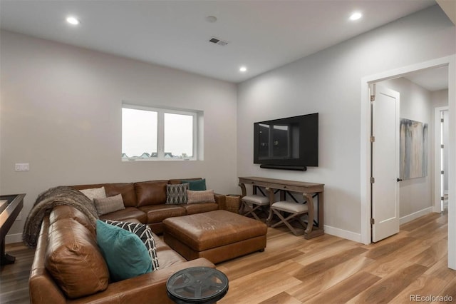 living area featuring light wood-style flooring, recessed lighting, visible vents, and baseboards