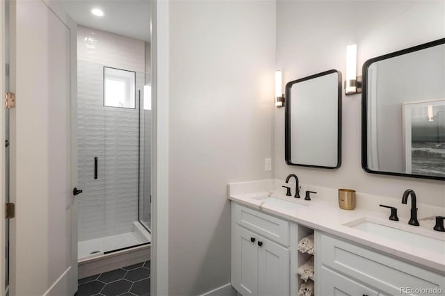 bathroom with double vanity, tile patterned floors, a stall shower, and a sink