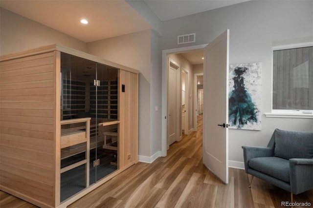 view of sauna / steam room featuring recessed lighting, baseboards, and wood finished floors