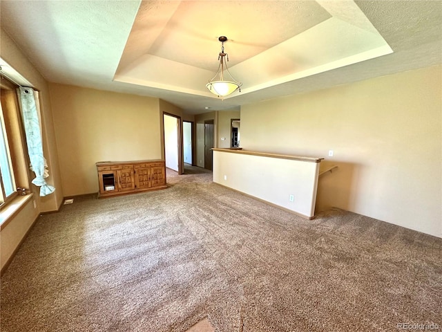 24938 County Road 18, Keenesburg, CO 80643 - spare room with a raised ceiling, carpet flooring, and baseboards