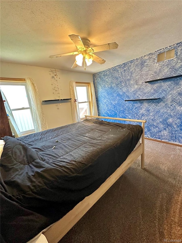 24938 County Road 18, Keenesburg, CO 80643 - carpeted bedroom featuring a textured ceiling and ceiling fan