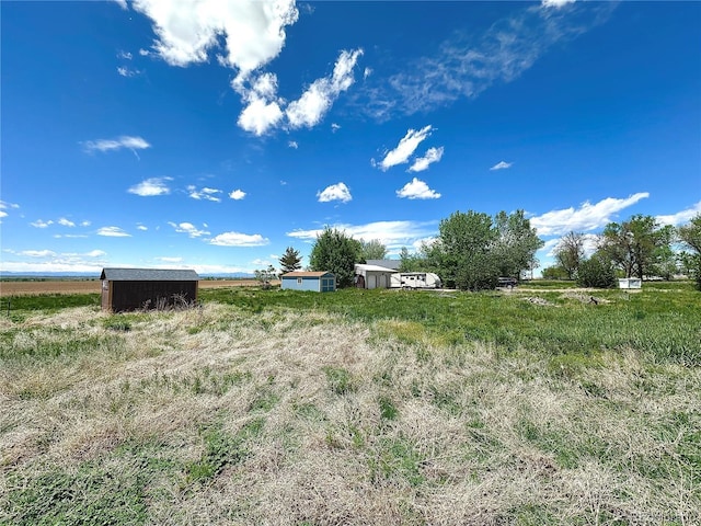 24938 County Road 18, Keenesburg, CO 80643 - view of yard featuring a shed, an outbuilding, and a rural view