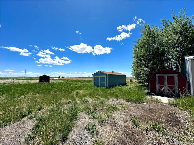 24938 County Road 18, Keenesburg, CO 80643 - view of yard with a shed, an outdoor structure, and a view of countryside