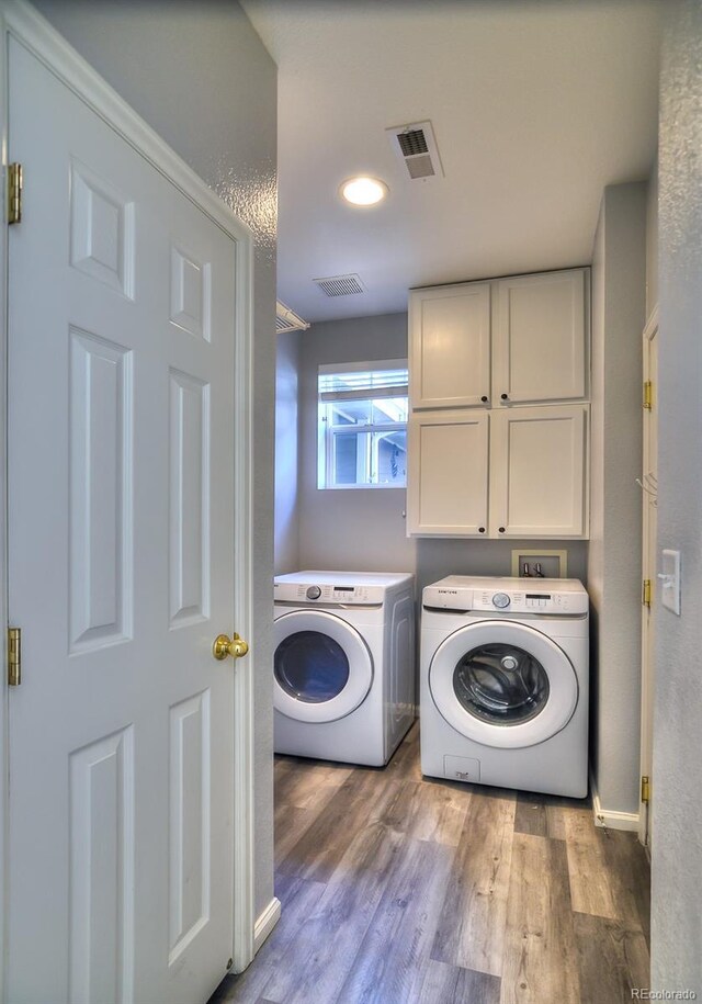 17205 Waterhouse Cir Unit C, Parker, CO 80134 - washroom featuring cabinet space, washer and clothes dryer, and wood finished floors