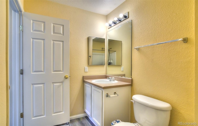 17205 Waterhouse Cir Unit C, Parker, CO 80134 - bathroom featuring vanity, a textured wall, and wood finished floors