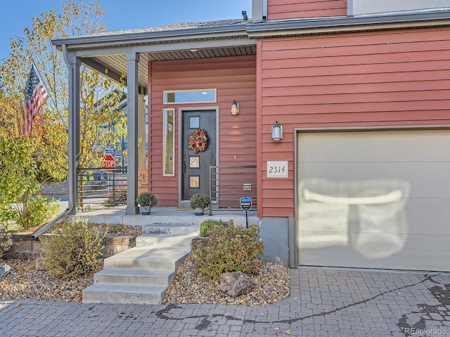 entrance to property with a porch and a garage