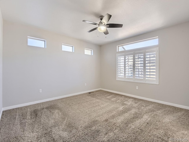 empty room featuring carpet flooring and ceiling fan