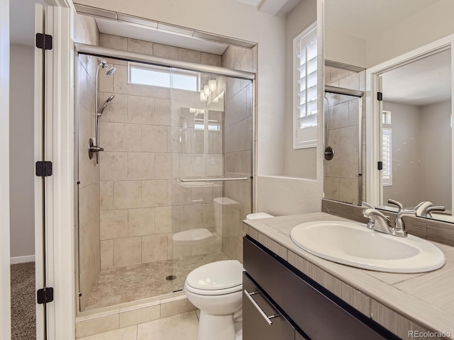 bathroom with tile patterned flooring, vanity, toilet, and a shower with door