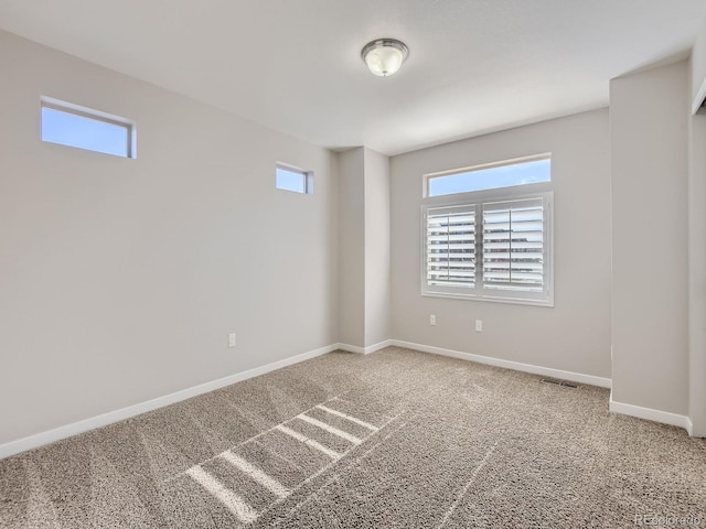 carpeted spare room with a wealth of natural light