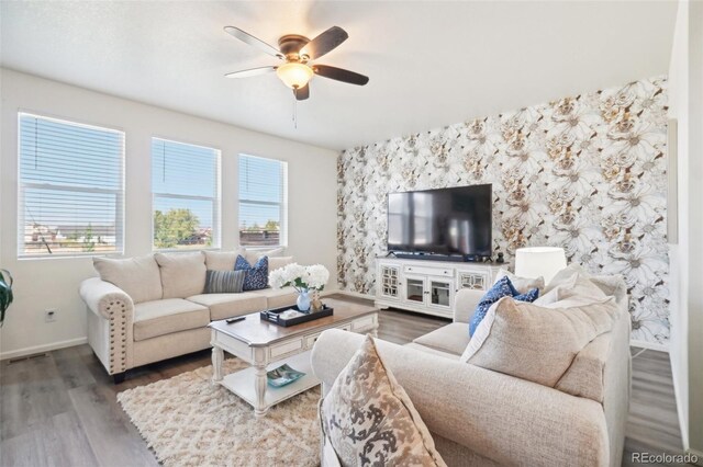 living room with wood-type flooring, a wealth of natural light, and ceiling fan