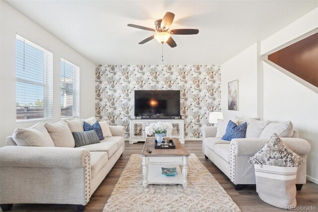 living room with ceiling fan and dark hardwood / wood-style flooring