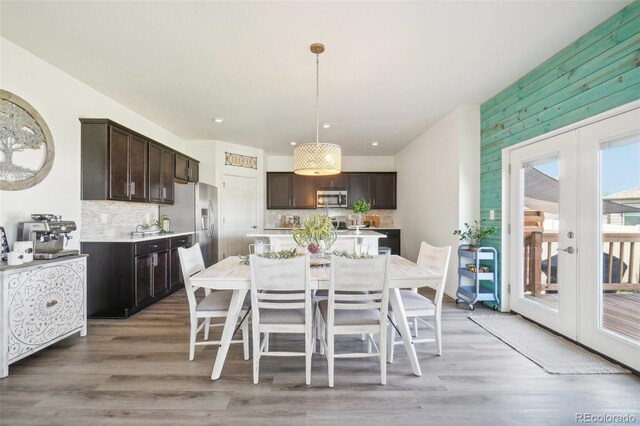 dining area with french doors and wood-type flooring