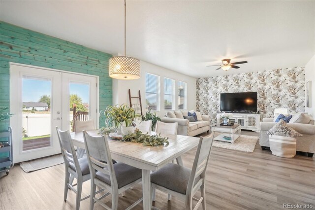 dining room with french doors, ceiling fan, and light hardwood / wood-style floors