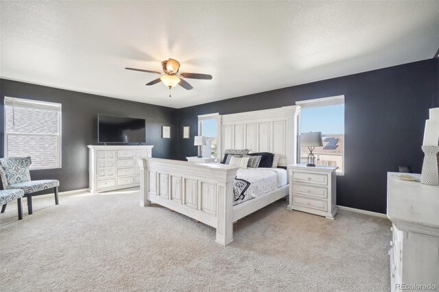 bedroom with multiple windows, light colored carpet, and ceiling fan