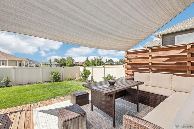 wooden deck featuring outdoor lounge area and a lawn