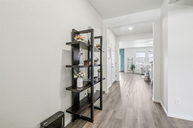 hallway with light hardwood / wood-style flooring