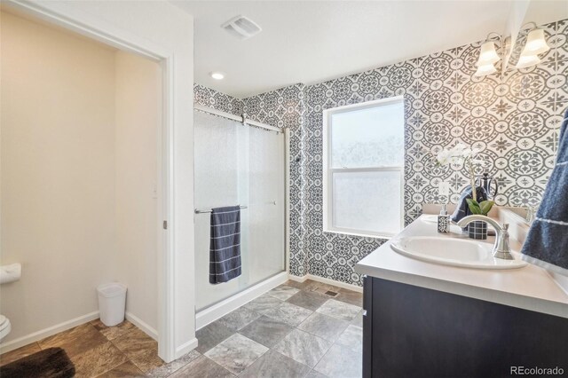 bathroom featuring walk in shower and vanity