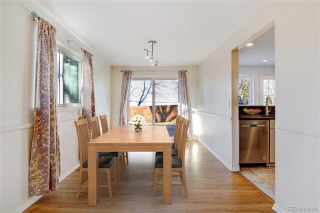 dining area featuring a healthy amount of sunlight and light hardwood / wood-style floors