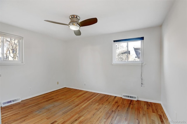 empty room featuring ceiling fan and light hardwood / wood-style floors