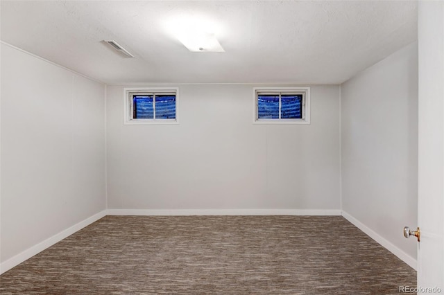 carpeted spare room featuring a textured ceiling