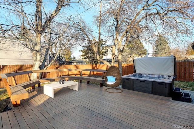 wooden deck featuring a hot tub