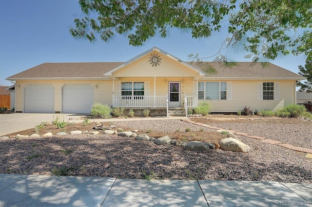 84 Kathy Dr, Buena Vista, CO 81211 - ranch-style house with a porch, an attached garage, and concrete driveway