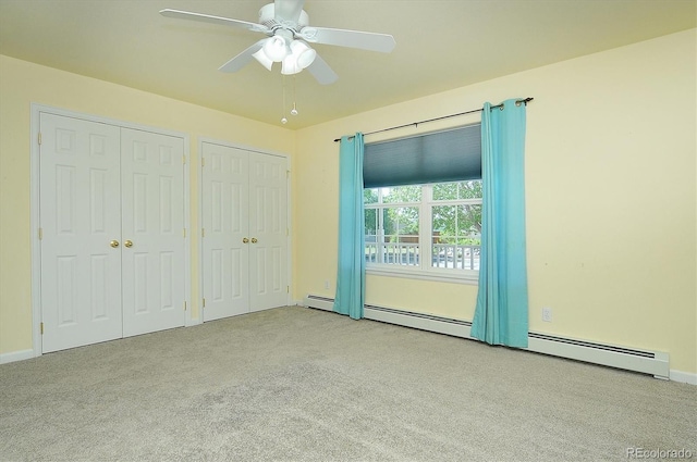 84 Kathy Dr, Buena Vista, CO 81211 - unfurnished bedroom featuring carpet floors, two closets, ceiling fan, and a baseboard heating unit