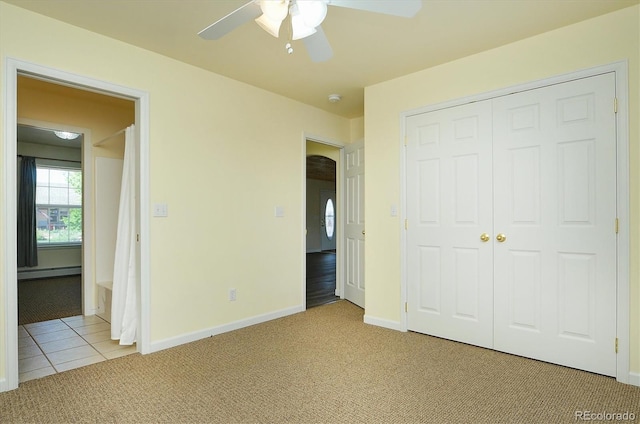 84 Kathy Dr, Buena Vista, CO 81211 - unfurnished bedroom featuring light colored carpet, a baseboard heating unit, a closet, a ceiling fan, and light tile patterned flooring
