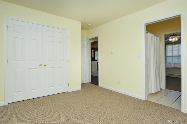 84 Kathy Dr, Buena Vista, CO 81211 - unfurnished bedroom featuring light carpet, a baseboard heating unit, arched walkways, and a closet