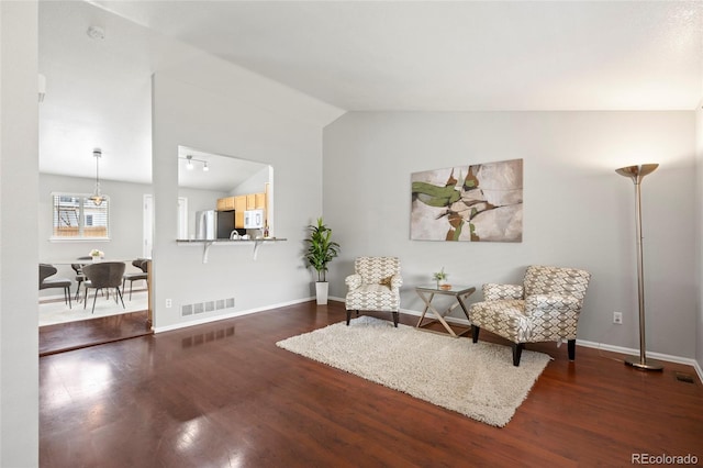 13906 Jackson St, Thornton, CO 80602 - living area with vaulted ceiling, wood finished floors, and baseboards