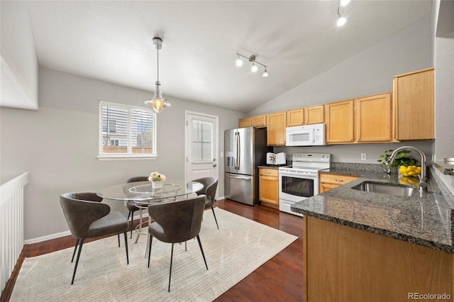 13906 Jackson St, Thornton, CO 80602 - kitchen featuring white appliances, a sink, track lighting, vaulted ceiling, and dark wood finished floors