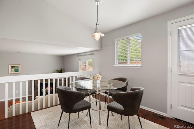 13906 Jackson St, Thornton, CO 80602 - dining area featuring wood finished floors, baseboards, plenty of natural light, and vaulted ceiling