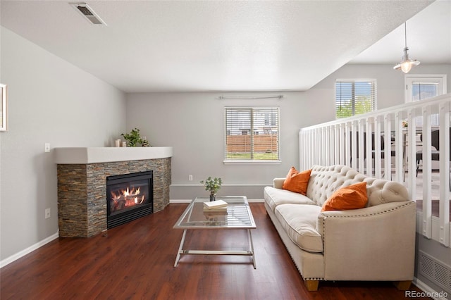 13906 Jackson St, Thornton, CO 80602 - living room featuring wood finished floors, a stone fireplace, and baseboards