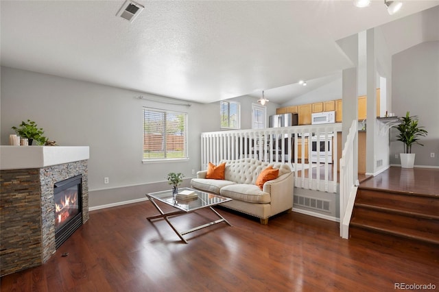13906 Jackson St, Thornton, CO 80602 - living area with vaulted ceiling, wood finished floors, a fireplace, and baseboards