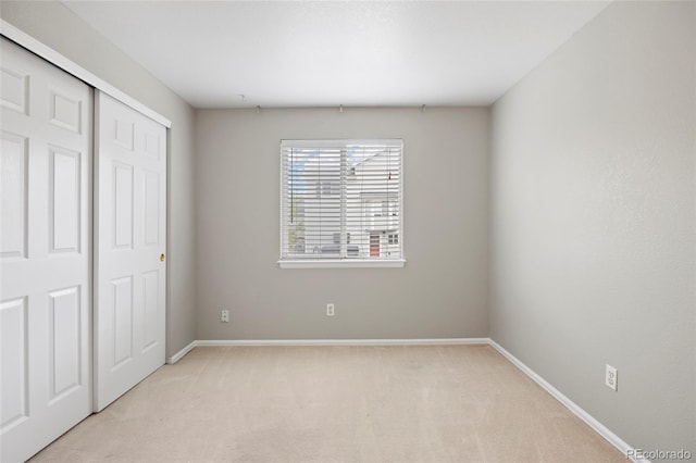 13906 Jackson St, Thornton, CO 80602 - unfurnished bedroom featuring light carpet, a closet, and baseboards