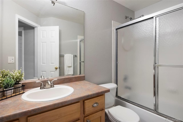 13906 Jackson St, Thornton, CO 80602 - full bathroom featuring vanity, toilet, combined bath / shower with glass door, and a textured wall