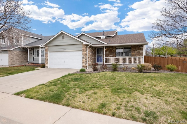 13906 Jackson St, Thornton, CO 80602 - view of front of home with a porch, an attached garage, concrete driveway, and stone siding