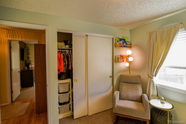 12498 W Prentice Dr, Littleton, CO 80127 - living area with a textured ceiling and wood finished floors
