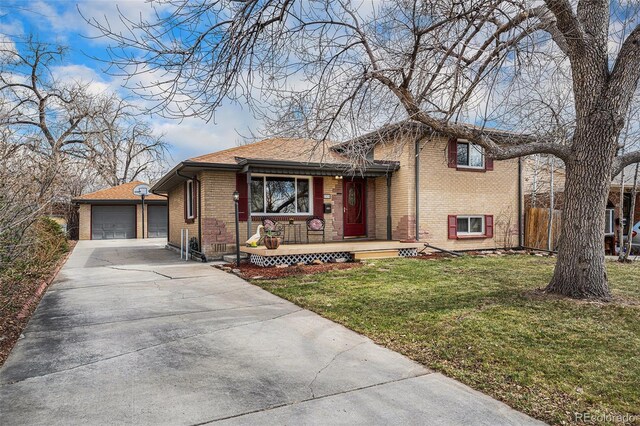 split level home featuring an outbuilding, driveway, a porch, a front lawn, and brick siding