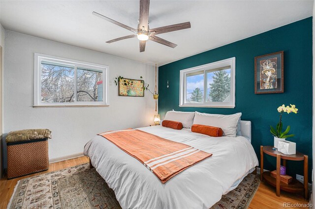 bedroom with ceiling fan and wood finished floors