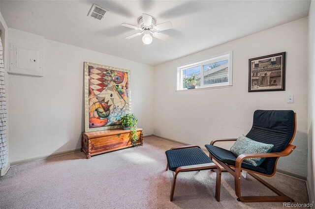 sitting room featuring visible vents, a ceiling fan, electric panel, carpet flooring, and baseboards