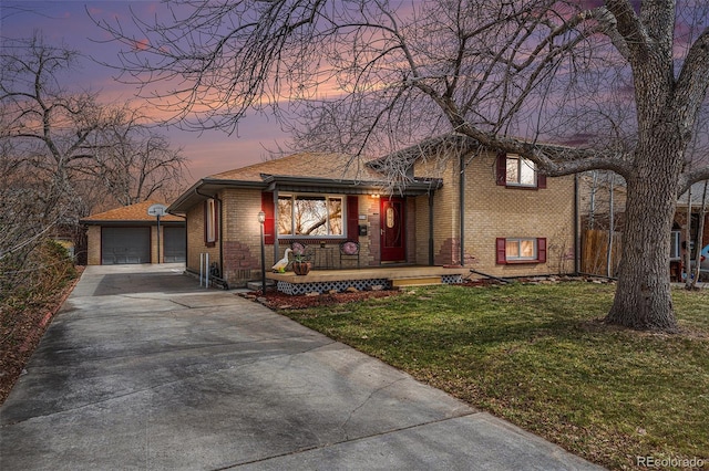 7930 Quitman St, Westminster, CO 80030 - split level home with a porch, brick siding, a yard, driveway, and a detached garage