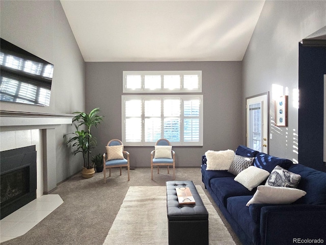 carpeted living room featuring lofted ceiling and a fireplace