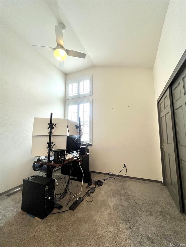 office with vaulted ceiling, ceiling fan, and carpet