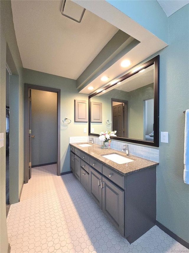 bathroom with vanity and decorative backsplash