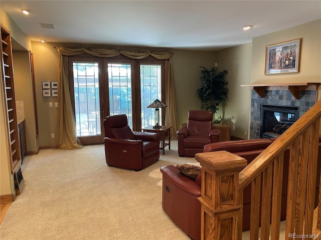 1145 S Williams St, Denver, CO 80210 - living area featuring a tile fireplace, light carpet, and french doors