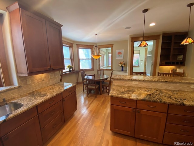 1145 S Williams St, Denver, CO 80210 - kitchen featuring decorative backsplash, light wood-style floors, light stone counters, and recessed lighting