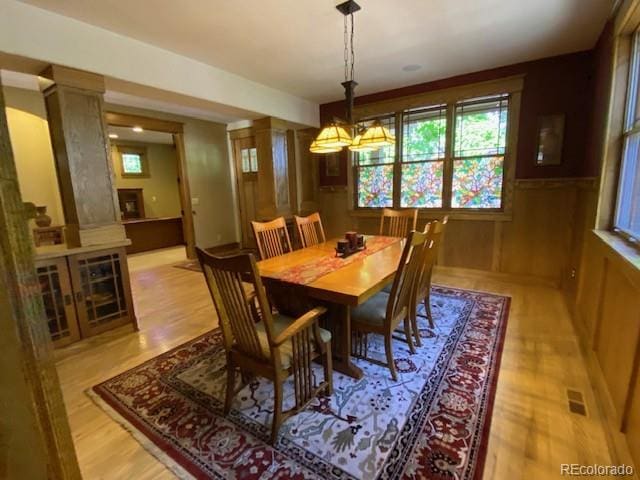 1145 S Williams St, Denver, CO 80210 - dining space with plenty of natural light, light wood-type flooring, wainscoting, and a chandelier